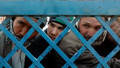 Afghan men line up to cast their votes during a parliamentary election at a polling station in Kabul, Afghanistan. REUTERS/Omar Sobhani TPX IMAGES OF THE DAY