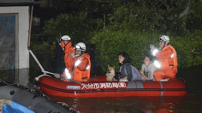 Local residents are evacuated by boat from a house flooded by the heavy rains brought by Typhoon Talim, in Oita, southern Japan, on September 17, 2017. Kyodo via Reuters