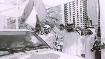 Sheikh Mohammed bin Zayed Al Nahyan, the Crown Prince of Abu Dhabi and Deputy Supreme Commander of the Armed Forces, waving the flag to mark the start of the first Desert Challenge stage that took place in Abu Dhabi, in 1992. Dr Mohammed Ben Sulayem is also seen on the left. Photo Courtesy / ATCUAE