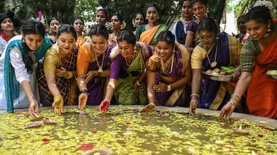 Indian students float lamps and flowers in a pool to celebrate the Aadi Perukku festival honouring the life-giving force of water, in Chennai, eastern India. AFP