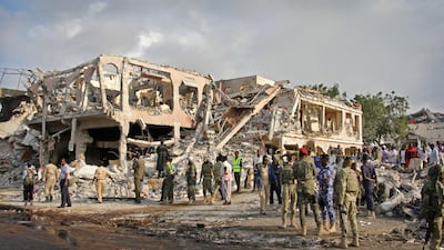 Somali security forces and others gather and search for bodies near destroyed buildings at the scene of Saturday's blast, in Mogadishu, Somalia. Farah Abdi Warsameh / AP Photo