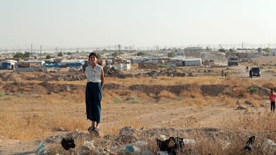 A girl watches the Syrian Kurds heading back to Ras Al Ain. AFP