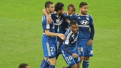 Lyon's Alexandre Lacazette celebrates with teammates during their Ligue 1 win over Reims on Sunday. Francois Nascimben / AFP / April 26, 2015