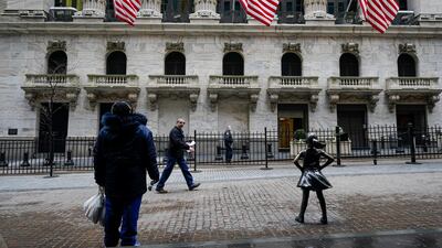 Pedestrians pass the New York Stock Exchange in New York. AP