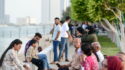 Families spend time at the corniche in Abu Dhabi. Khushnum Bhandari / The National
