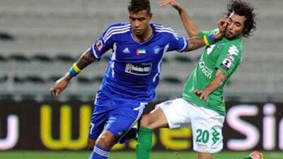 Nasser Masood, right, of Al Shabab, gets forced off the ball by Leonardo Lima of Al Nasr in last night's 1-1 Etisalat Cup draw.