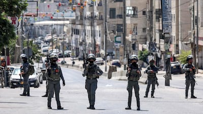 Israeli forces stand guard during the raid. AFP