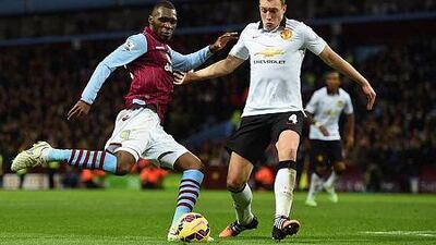 Christian Benteke, left, of Aston Villa is closed down by Jonny Evans of Manchester United during their Premier League match at Villa Park on December 20, 2014 in Birmingham, England. (Photo by Michael Regan/Getty Images)
