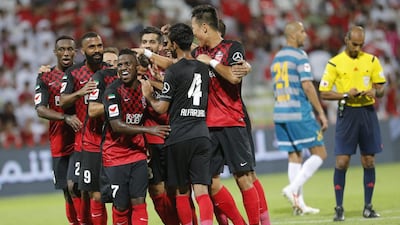 Al Ahli celebrate scoring one of their eight goals against Fujairah during the league opener in Dubai on Wednesday night. Hasan Alraesi / Al Ittihad