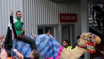 Emirati driver Khaled Al Qubaisi of Team Abu Dhabi by Black Falcon takes a celebratory ride after finishing in third place at the 24 Hours of Dubai. Satish Kumar / The National