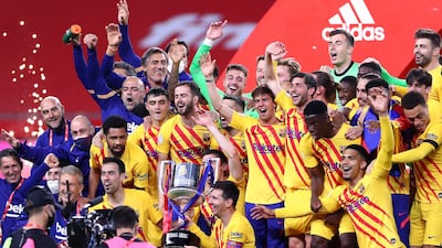 Barcelona's Lionel Messi lifts the trophy with celebrating teammates after winning the Copa Del Rey final against Athletic Bilbao. Getty