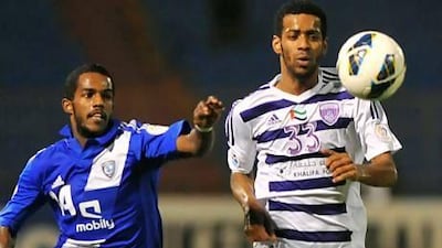 Al Ain’s Mohammed Salem, right, gets a step on Nawaf Al Abid of Saudi Arabia’s Al Hilal during their ACL match Tuesday night in Riyadh. Fayez Nureldine / AFP