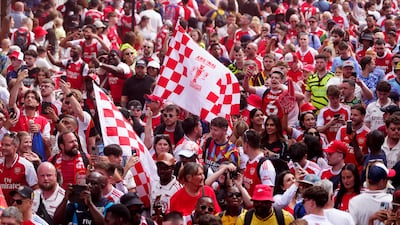 Arsenal fans attend the open-top bus parade in London. PA