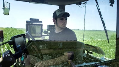 Andrew Isaacson watches from the cockpit of a tractor as screens show where he has fertilised a corn field at the Little Bohemia Creek farm in Warwick, Maryland. Brendan Smialowski / AFP