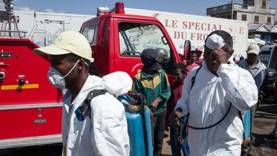 Council workers ready to start the clean-up operation of the market of Anosibe, a run down district of Antananarivo on October 10, 2017. The World Health Organisation has warned that a deadly outbreak of the plague, which began in late August, is swiftly spreading in cities across the country. AFP PHOTO / RIJASOLO