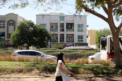 Walkable areas with amenities, greenery and access to public transport are seen as important in cutting dependency on cars. Chris Whiteoak / The National
