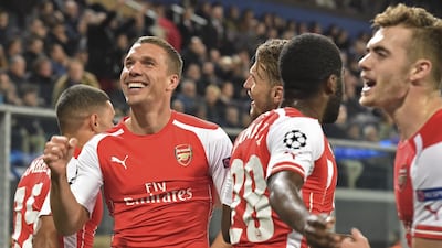 Arsenal's Lukas Podolski, second left, celebrates after scoring Arsenal's winner in a 2-1 Champions League victory over Anderlecht on Wednesday night in Brussels. Geert Vanden Wijngaert / AP / October 22, 2014