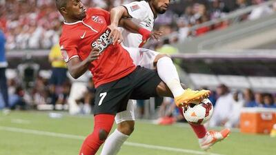 Al Ahli's Ismail Al Hammadi, left, battles for the ball during the Arabian Gulf Cup final between against Al Jazira at Hazza bin Zayed Stadium on April 19, 2014. Al Hammadi hit the game-winner in the 81st minute for Ahli. Al Ittihad