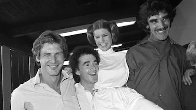 In this October 5, 1978 photo, from left, actors Harrison Ford, Anthony Daniels, Carrie Fisher and Peter Mayhew take a break from filming a television special in Los Angeles to be telecast during the holidays. George Brich / AP photo