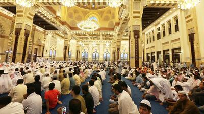 People attend Eid Al Fitr morning prayer at Zabeel Mosque in Dubai. Pawan Singh / The National