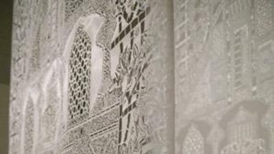 Afruz Amighi's 1001Pages casts an intricate pattern of shadows against the wall.