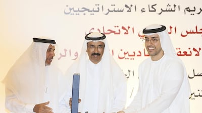 Dr Mohammed Al Mazrouei, General Secretary of the FNC, and Mohammed Al Murr, the council’s Speaker, present Mohammed Al Otaiba, Editor-in-Chief of The National, with the award in Abu Dhabi. Sarah Dea / The National