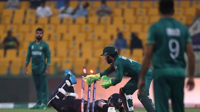Pakistan's wicketkeeper Mohammad Rizwan, second right, runs out Namibia's Stephan Baard. AP