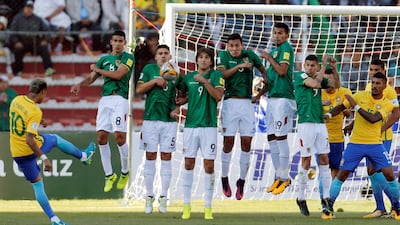 Neymar attempts to shape a free-kick over the Bolivia wall. David Mercado / Reuters