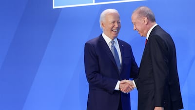 Mr Biden greets Turkey's President Recep Tayyip Erdogan. Bloomberg