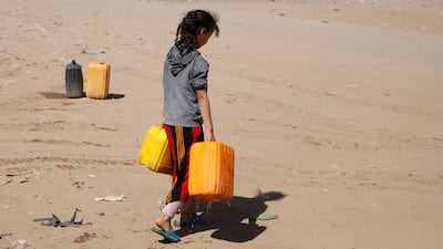 A Yemeni girl carries water from a donated tank on the outskirts of Sanaa, on November 24. EPA