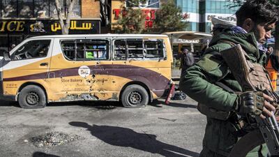 Security forces stand outside Slice Bakery in Share-Naw, where one of the rockets hit, damaging a delivery van and injuring several people. Stefanie Glinski for The National
