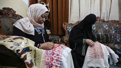 Palestinian refugees in Jordan embroider traditional dresses for their customers at Al Baqaa refugee camp, near Amman. Reuters