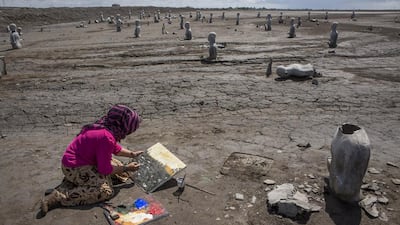An artist, Novi, paints at the mudflow site during the anniversary of the eruption. Ulet Ifansasti / Getty Images