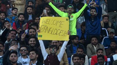 Spectators cheer at Gaddafi Stadium in Lahore on Friday. AFP