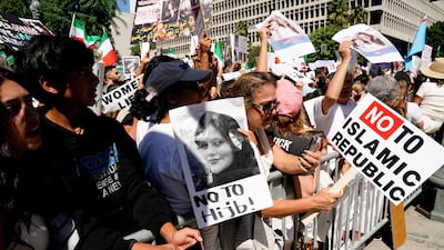 Demonstrators display images of Mahsa Amini at a Freedom Rally for Iran outside City Hall in Los Angeles, California, on October 1, 2022. Reuters