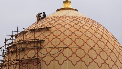 Workers restore a dome of Al Shaab Mosque in Sanaa, Yemen. EPA
