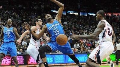 Scott Brooks, left, the Oklahoma City coach, talks to Kevin Durant during a break against the Atlanta Hawks in which the Thunder conceded 21 turn overs on Friday as they lost 97-80. Erik Lesser / EPA