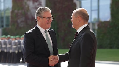 German Chancellor Olaf Scholz greets Mr Starmer at the Chancellery in Berlin, in August