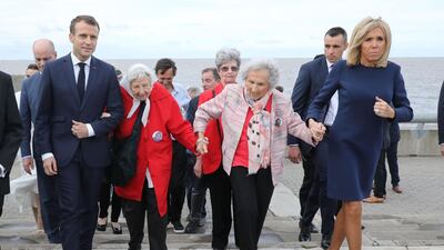 France's President Emmanuel Macron wife Brigitte walk with human rights activists during a visit to the Remembrance Park --a monument on the banks of the Rio de la Plata- in memory of the 30,000 people who disappeared or were killed under the 1976-1983 military regime. AFP
