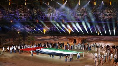 Performers unfurl the UAE flag during celebrations at the Zayed Sports Stadium. EPA /Ali Haider