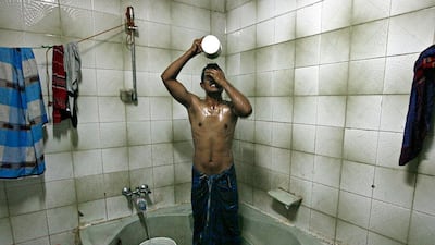 A labourer takes a bath.