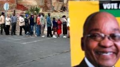 Voters queue behind a poster of Jacob Zuma outside a polling station in Alexandra Township.