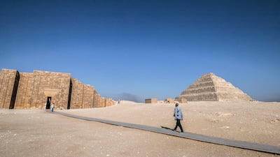 A security guard carries an assault rifle near the step pyramid. AFP