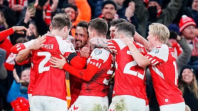 Denmark midfielder Thomas Delaney is mobbed after scoring the goal to send his side to Euro 2024. AFP