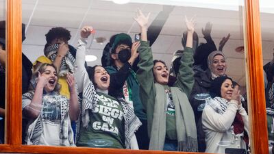 Supporters of Chicago City Council's Gaza ceasefire resolution cheer from the second-floor gallery after it passes. AP