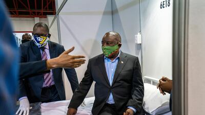 South African President Cyril Ramaphosa visits a Covid-19 treatment facility in Johannesburg. The country has had the highest number of infections on the continent, with more than 21,000 confirmed cases as of Sunday, according to Johns Hopkins University. AP Photo