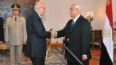 Pro-democracy leader Mohamed ElBaradei, a leader of the National Salvation Front, centre left, shakes hands with interim President Adly Mansour after being sworn in as vice president.