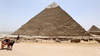 Tourists ride horse carts and camels at the Giza pyramids. Mohamed Abd El Ghany / Reuters