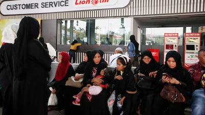 Passengers await for their flight in front of a Lion Air office at Soekarno Hatta International airport. Reuters