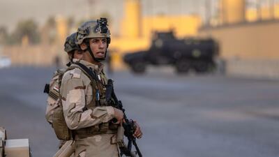 Iraqi Army soldiers stand guard on a road between the US Embassy and the International Zone on May 30, 2021 in Baghdad, Iraq. AFP